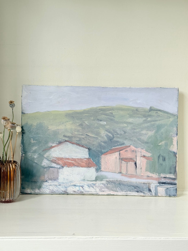 Unframed vintage oil painting of hillside cottages with terracotta roofs, green landscape, and textured brushwork, on white surface.