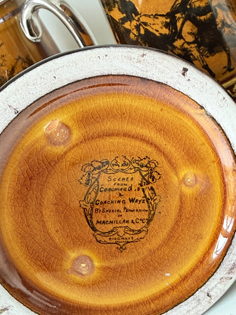 Set of 4 large Ridgways stoneware beer tankards photographed on a white surface in amber treacle glaze with black Coaching Days and Coaching Ways transfer scenes