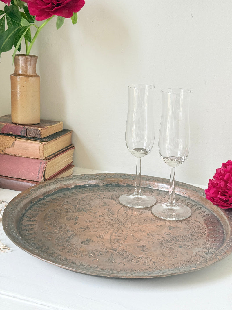 Vintage hand engraved copper tray with sunburst centre, decorative border and aged verdigris patina for wall or tabletop styling
