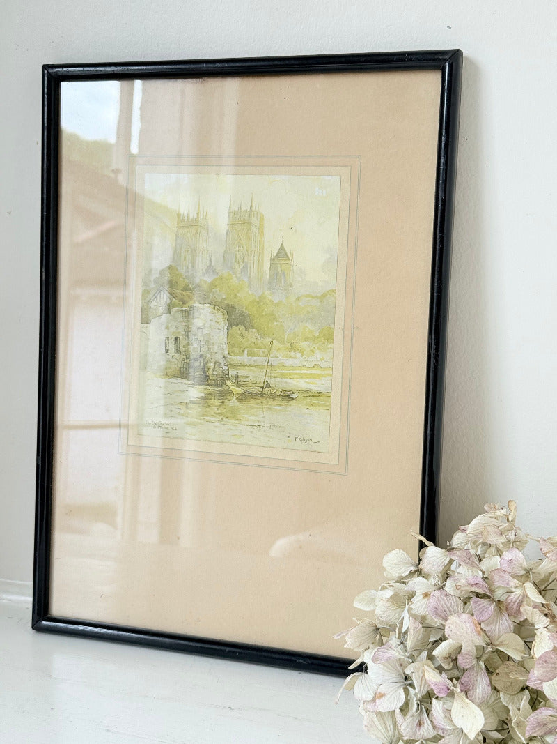 framed print of york minster and city walls in black frame, photographed on white surface