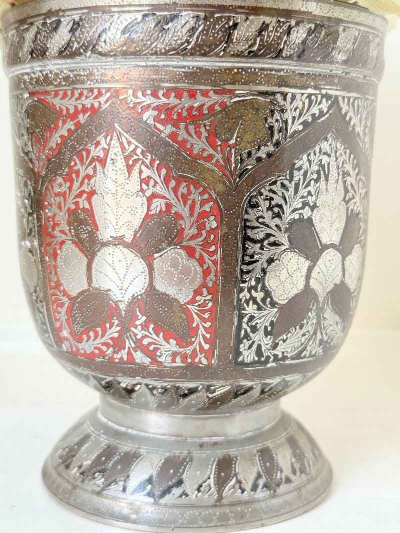 vintage indian metal lassi cup with red and white enamel motifs, styled with dried hydrangeas on a white surface