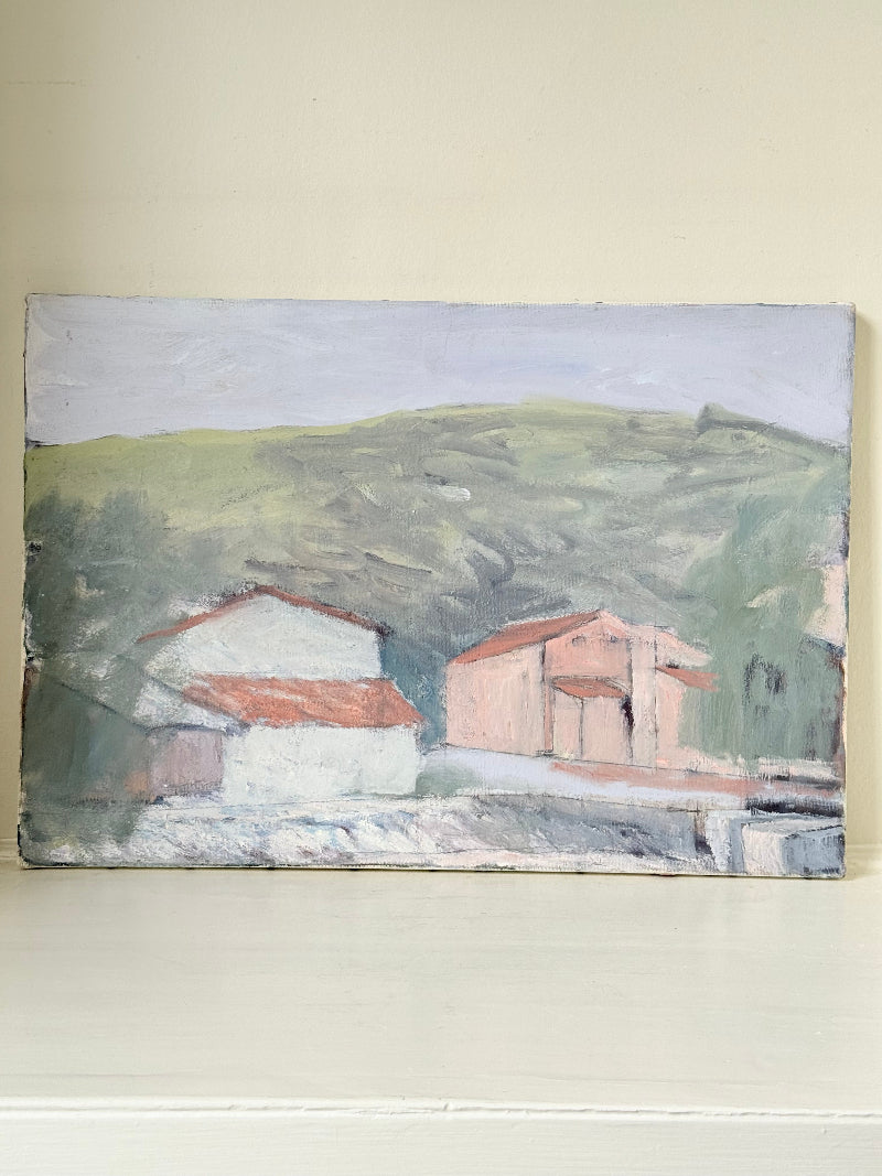 Unframed vintage oil painting of hillside cottages with terracotta roofs, green landscape, and textured brushwork, on white surface.