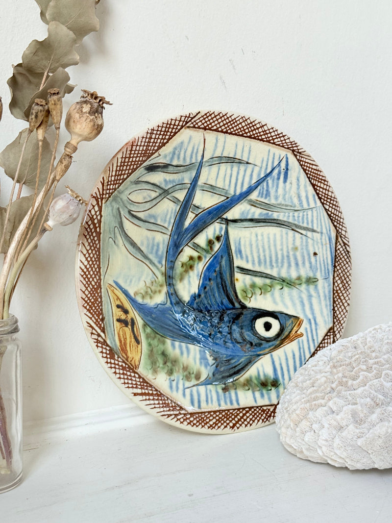 Vintage Puidgemont hand painted fishbowl with blue fish motif, photographed on a white surface