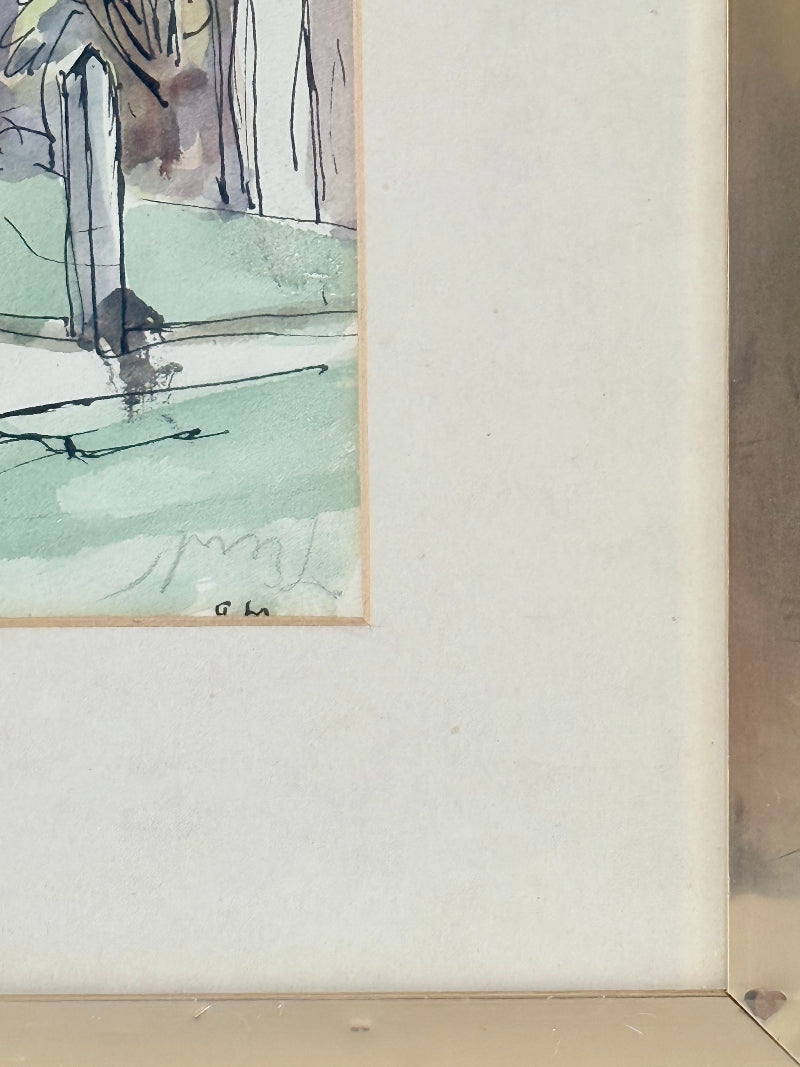 Framed vintage watercolour painting of a large tree and brick house, photographed on a white surface.