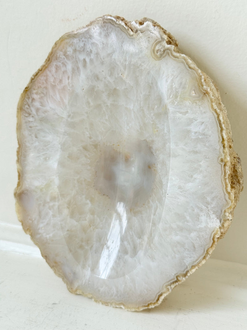 Vintage natural agate stone soap dish in grey and white, photographed on a white surface.