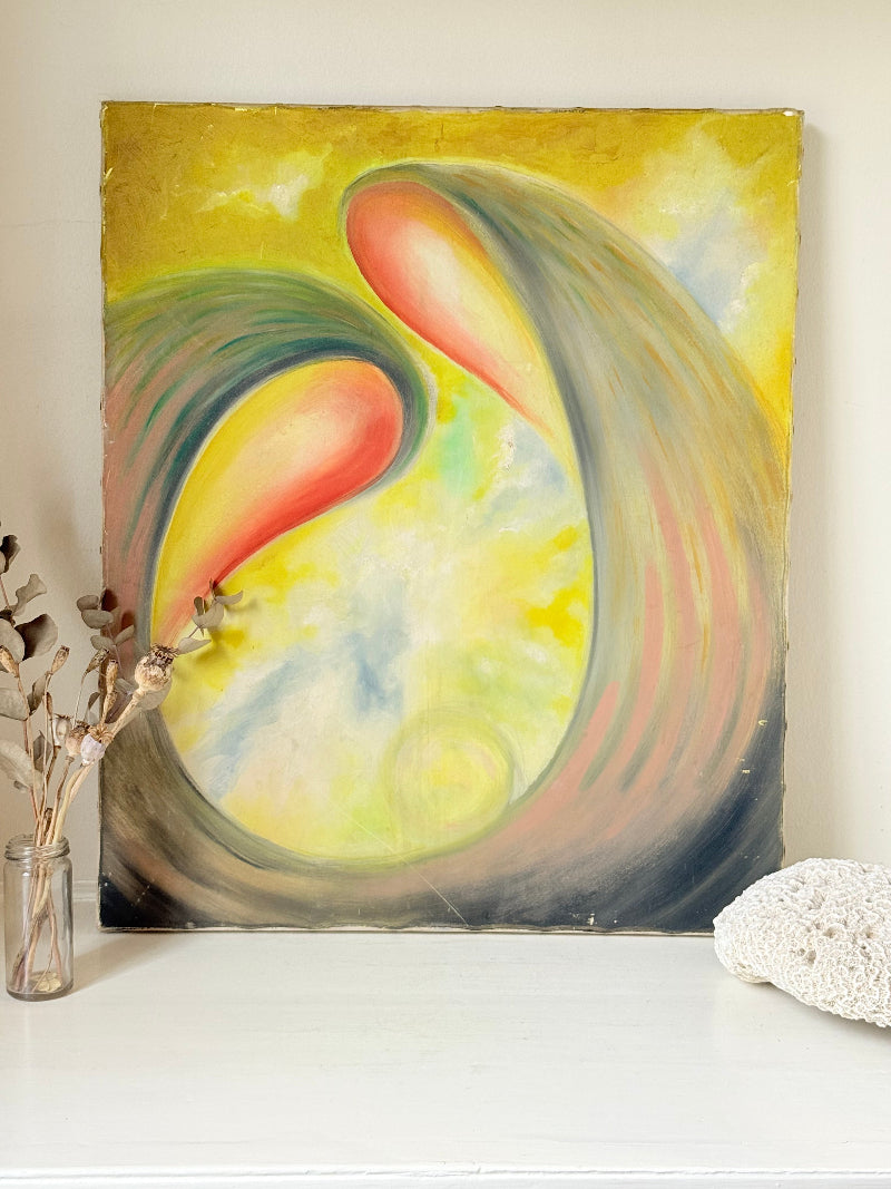 Abstract oil painting on canvas in yellow, pink and grey tones, photographed upright on a white surface.