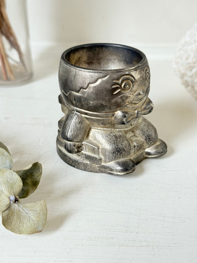Vintage Humpty Dumpty silver plate egg cup, photographed on a white surface