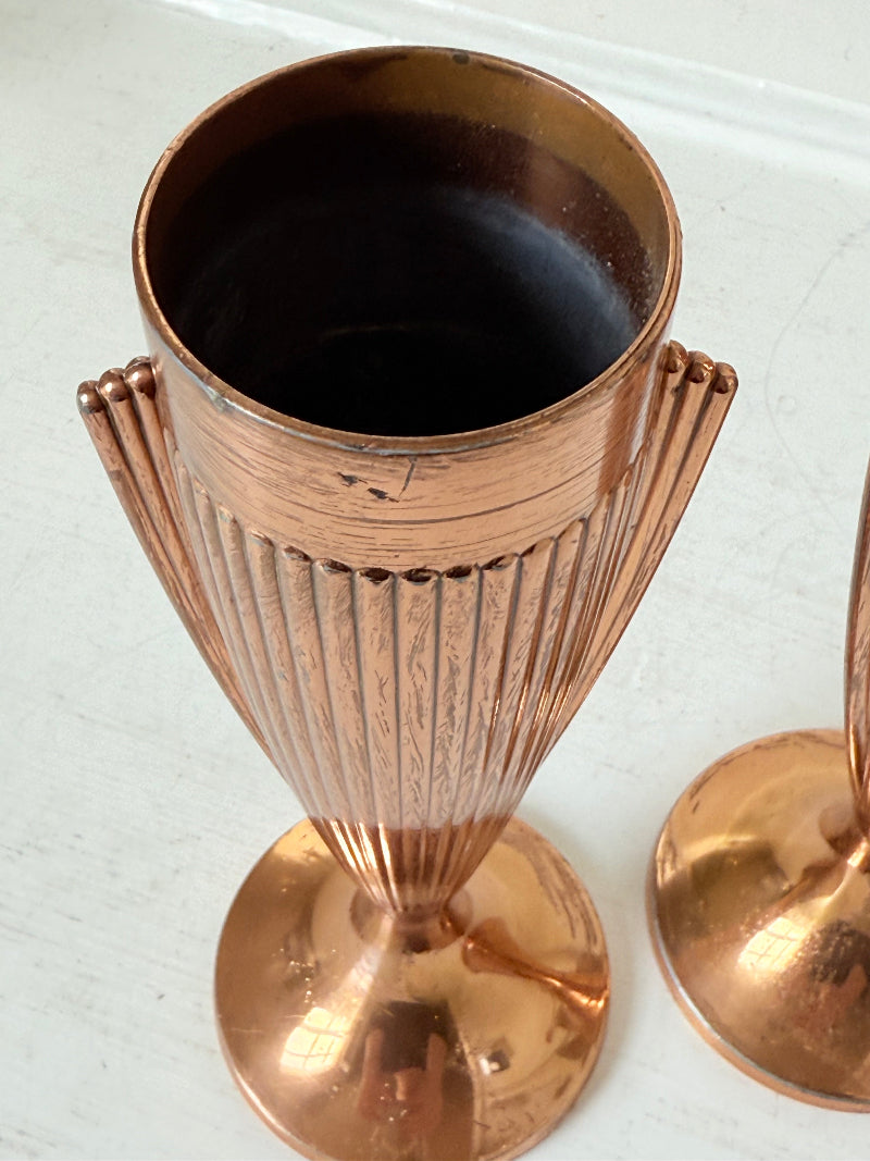 Pair of vintage copper Art Deco vases with fluted surface, photographed on a white background.