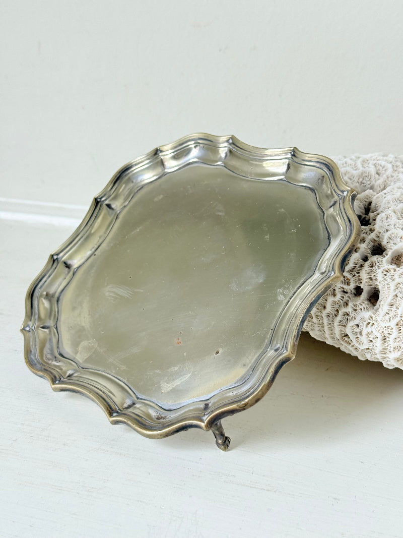 Vintage silver plate tray with scalloped edge and footed base, photographed on a white surface