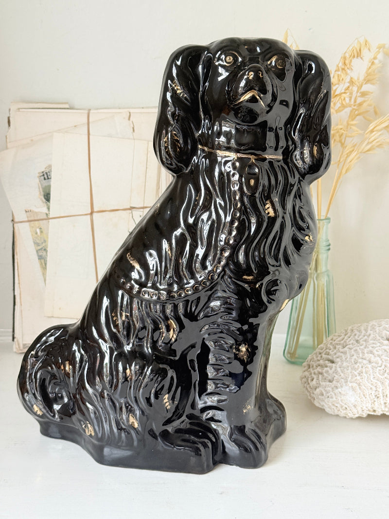 Vintage Staffordshire style black ceramic spaniel dog with gold lustre collar, glossy glaze and textured coat detail