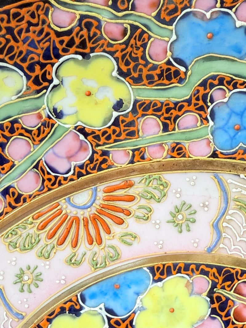 Antique Japanese Aoki Brothers platter with colourful Imari style floral pattern photographed on a white surface