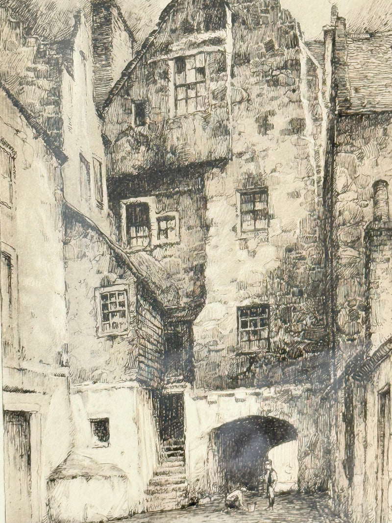 framed black and white print of edinburgh old town architecture photographed on white surface