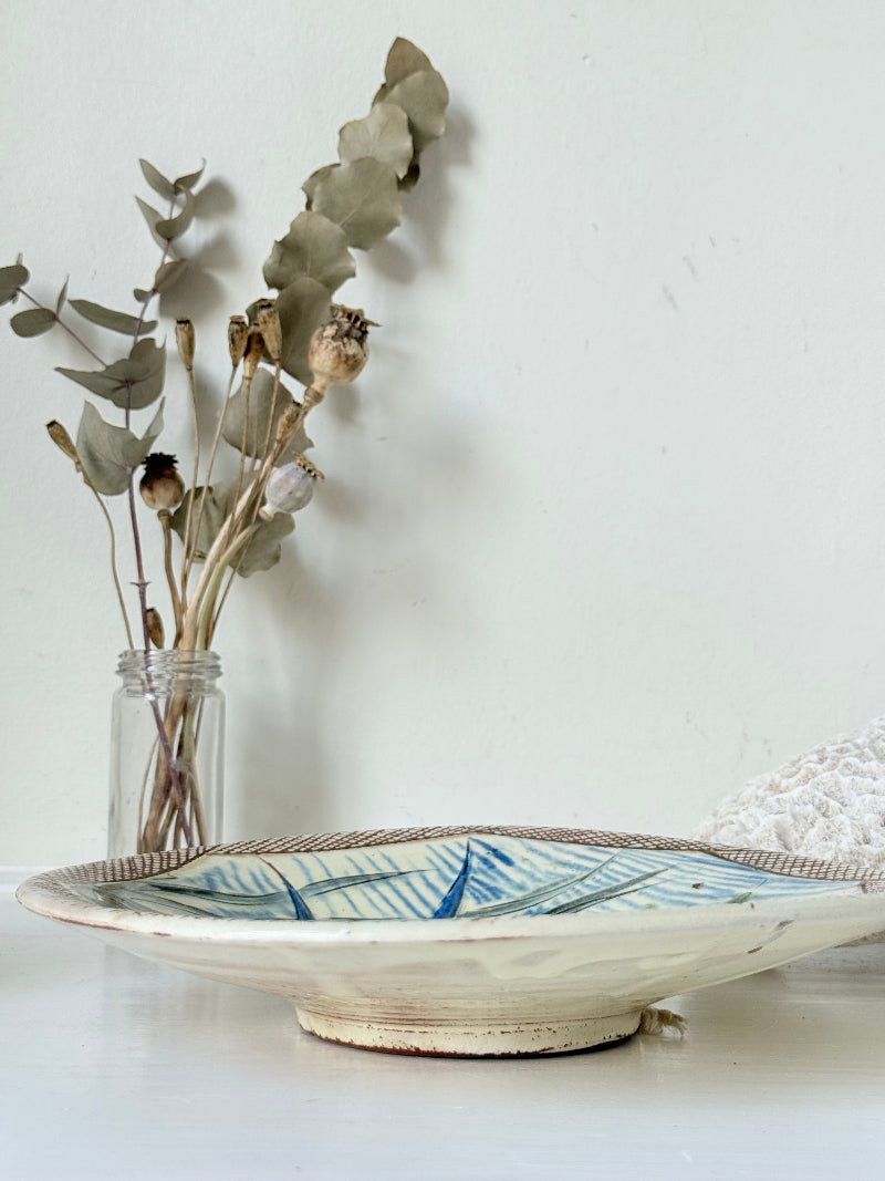 Vintage Puidgemont hand painted fishbowl with blue fish motif, photographed on a white surface