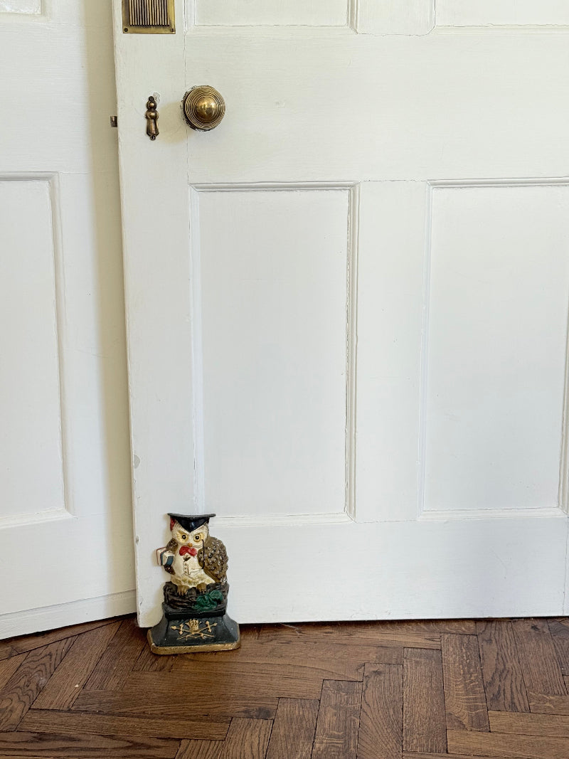vintage hand painted cast iron owl doorstop with mortarboard and bow tie on white surface
