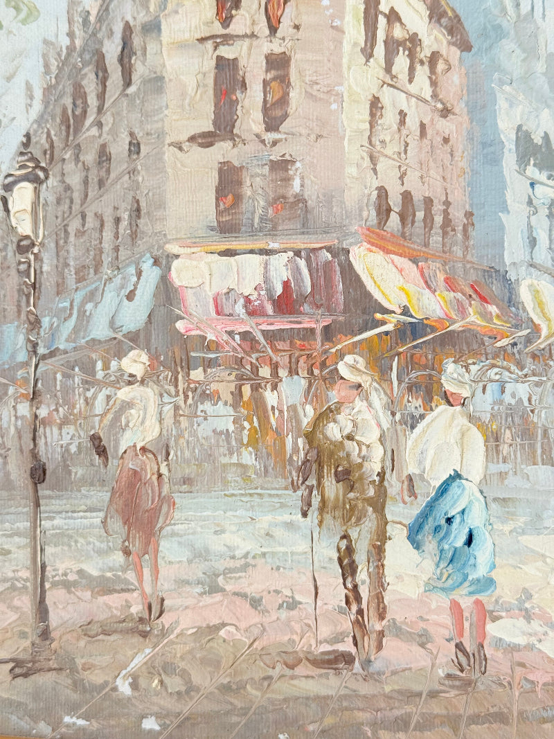 Vintage oil painting of European street scene with buildings and awnings in wooden frame photographed on a white surface