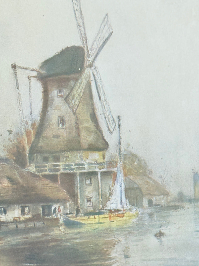 framed print of dutch windmill beside water in holland with reflection photographed on white surface