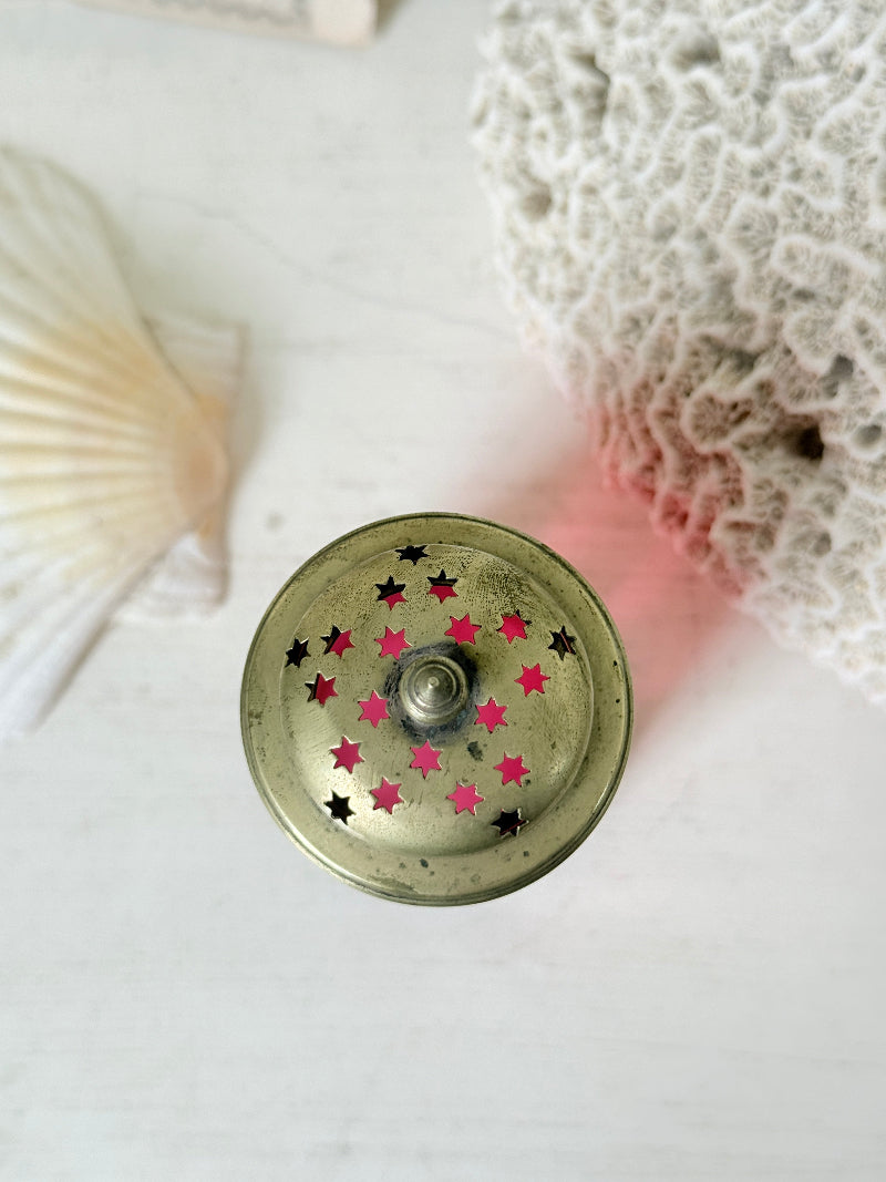 Antique cranberry glass sugar shaker with ribbed optic body, pierced metal top, star holes and deep pink glass