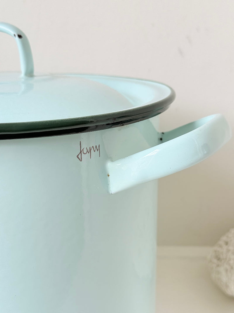 Vintage pale blue enamel bread bin with lid and handles, photographed on a white surface