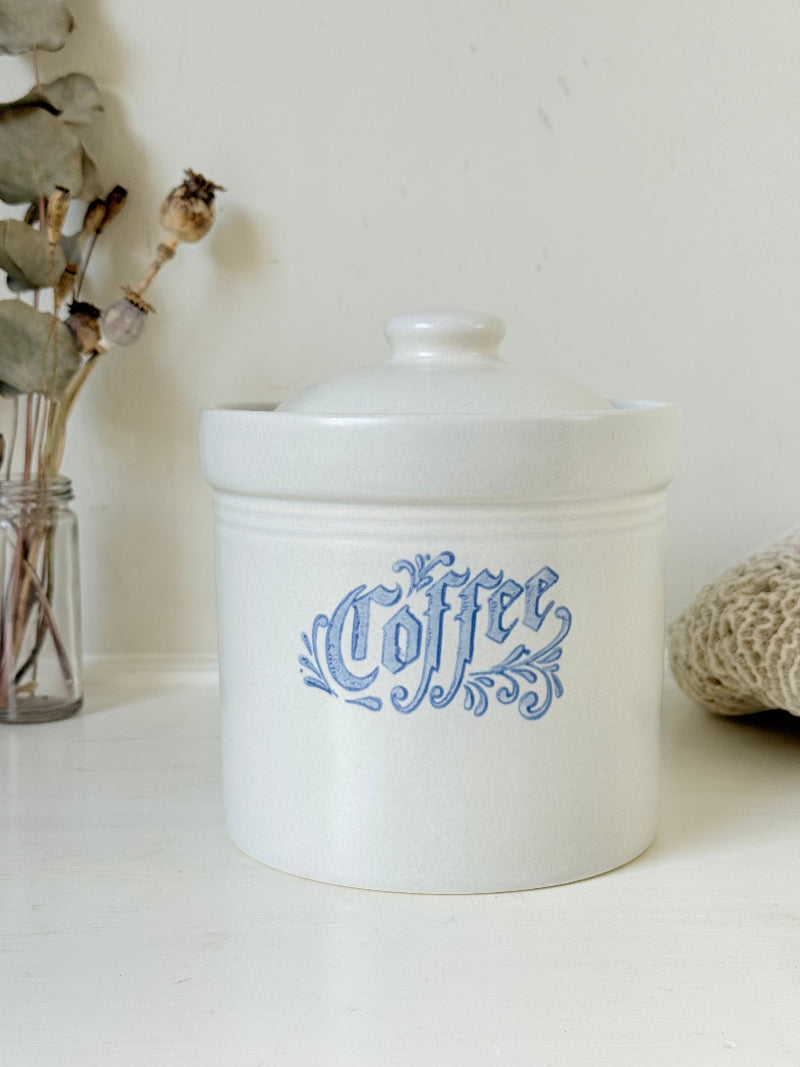 Pfaltzgraff Yorktowne stoneware coffee jar with blue floral motif and lid, photographed on a white surface