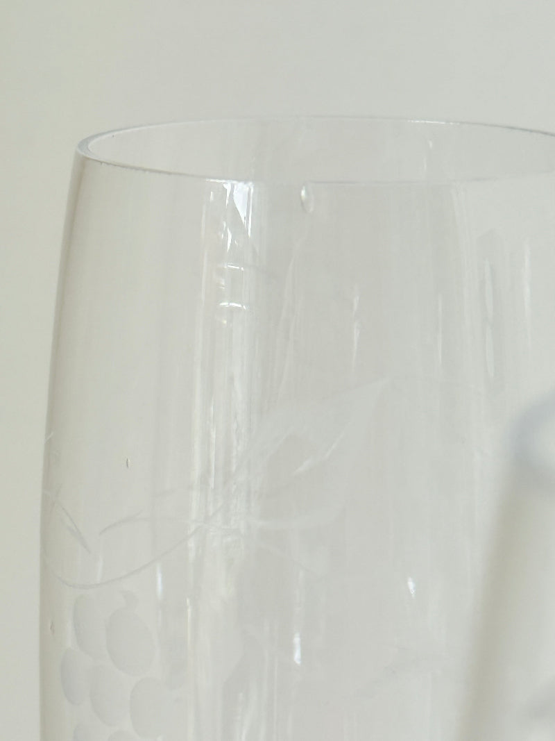 Set of six vintage French champagne flutes with tall clear bowls and cobalt blue twisted stems, photographed on white surface.