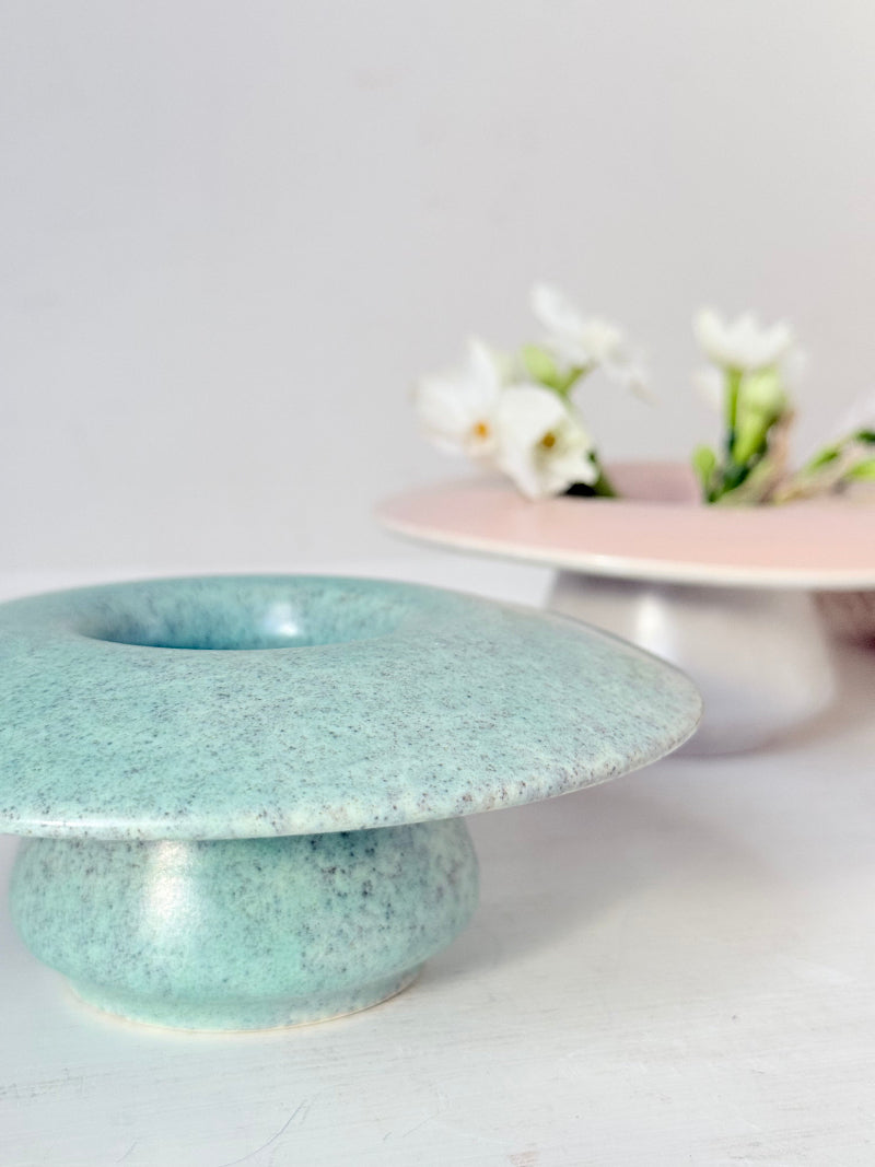 Pair of Poole Pottery mushroom posy vases in seafoam green and blush pink glazes photographed on a white surface