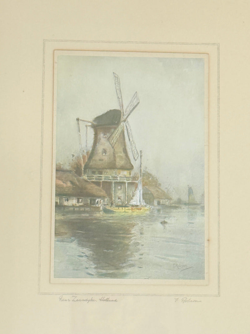 framed print of dutch windmill beside water in holland with reflection photographed on white surface