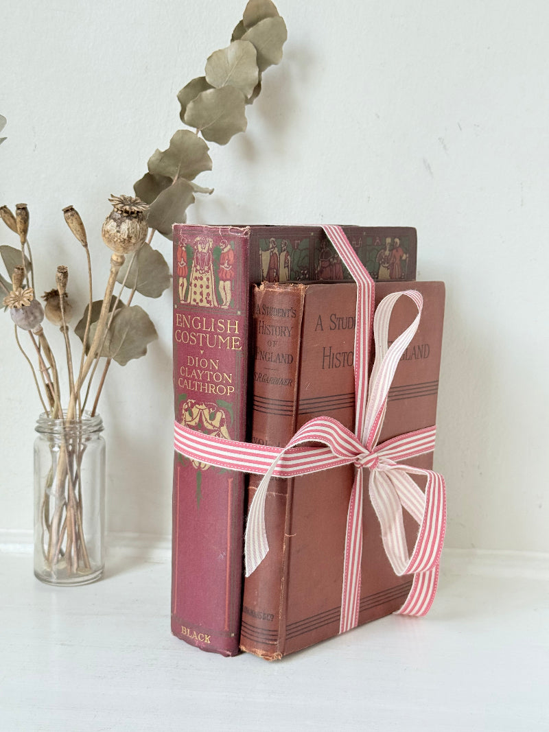 Vintage book bundle of English Costume and History of England with burgundy and brown hardback covers, photographed on a white surface