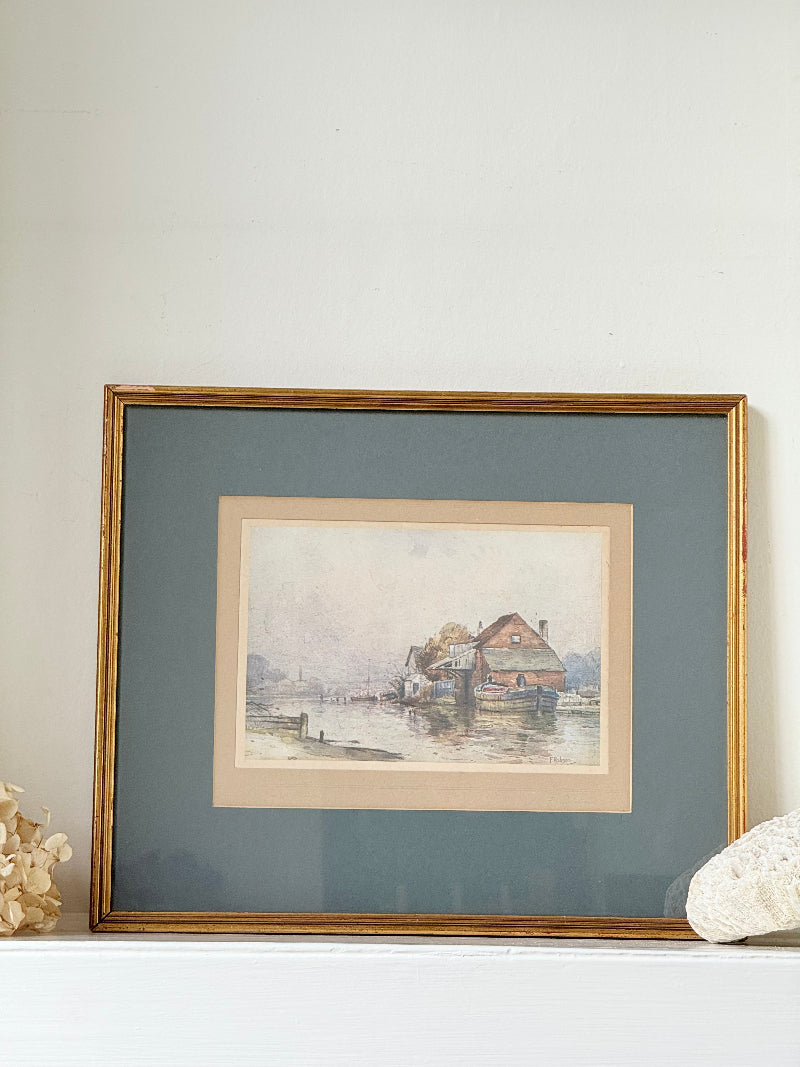 Vintage framed print of riverside mill by F Robson, gilt frame with blue mount, rustic water scene, photographed on white surface.