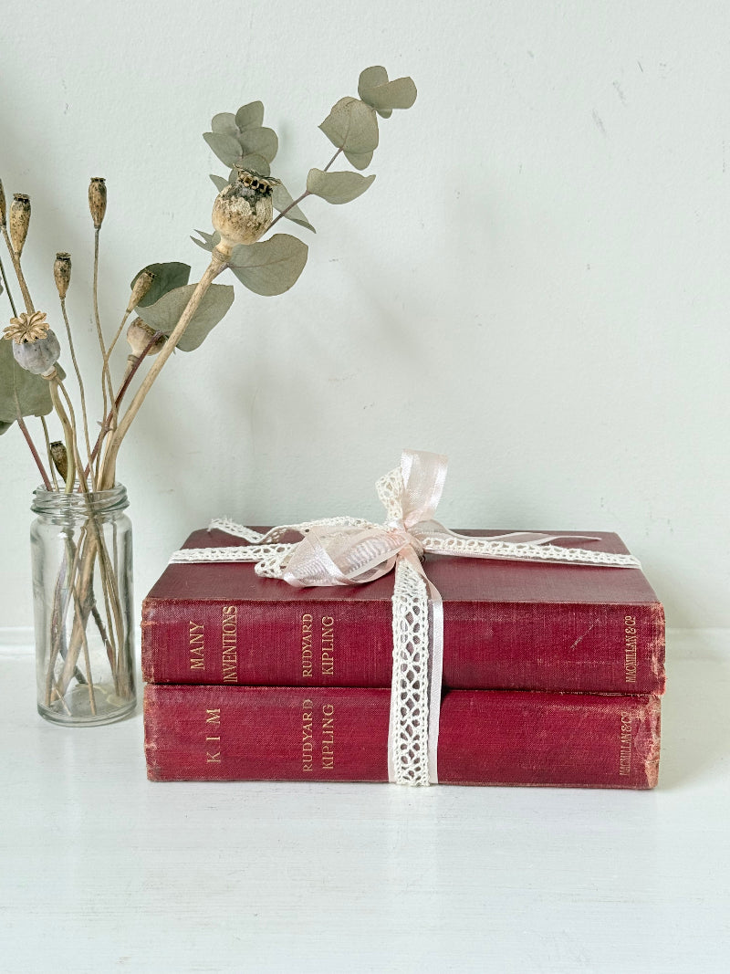 Vintage Rudyard Kipling book bundle of Kim and Many Inventions in red hardback covers, photographed on a white surface