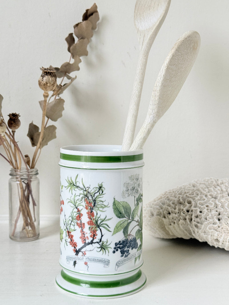 Vintage Kaiser W Germany porcelain utensil jar with botanical floral pattern and green rim photographed on a white surface