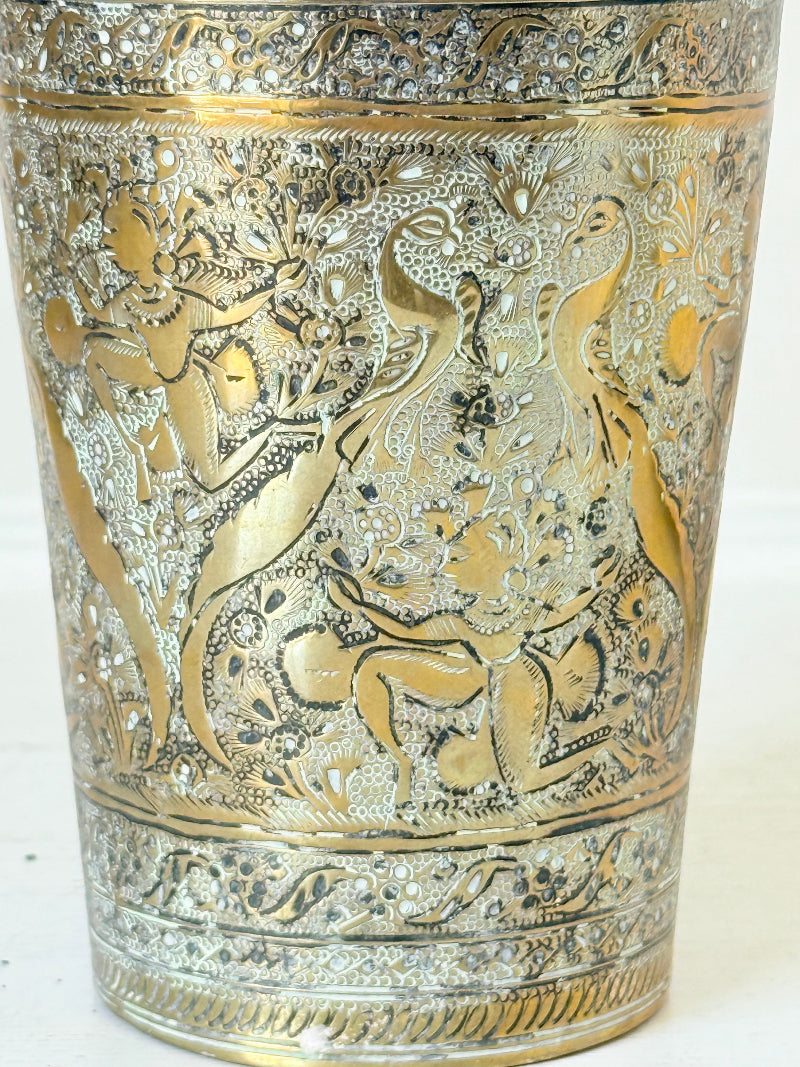 Indian Benares brass jar with lid and engraved animals and floral design, photographed on a white surface