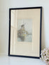 framed print of dutch windmill beside water in holland with reflection photographed on white surface