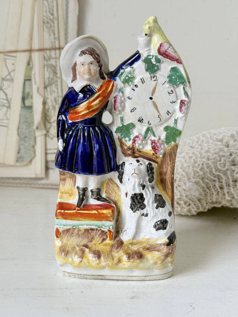 Victorian Staffordshire flatback clock group with girl spaniel and parrot hand painted in cobalt blue and orange