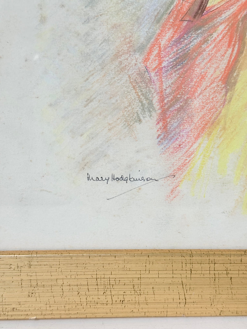 Vintage pastel portrait of a woman in profile wearing red and yellow, framed under glass, photographed on a white surface