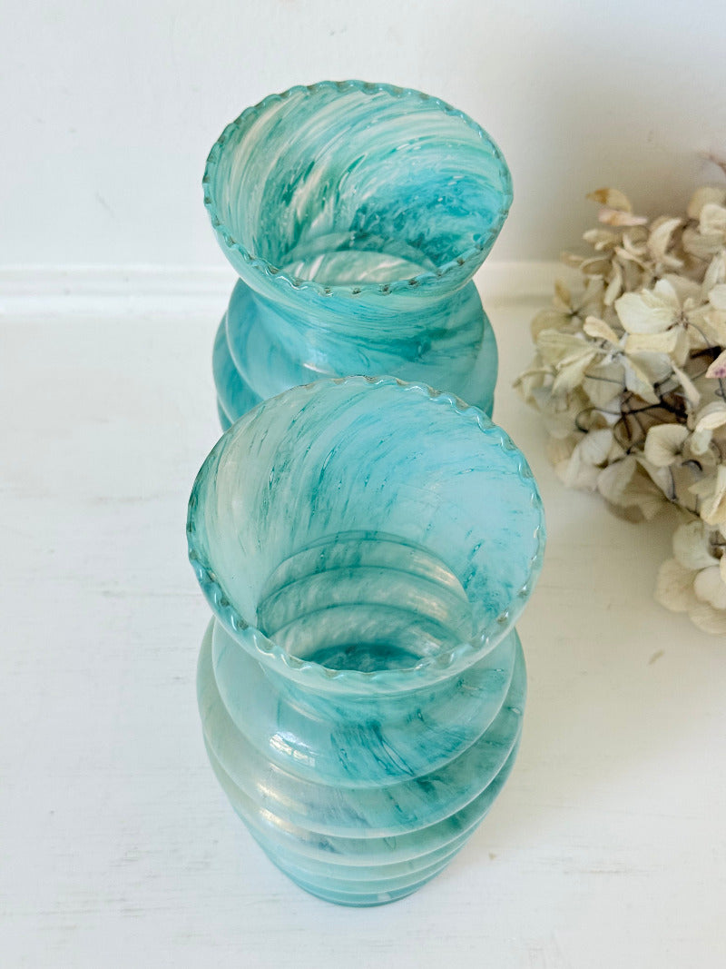 Pair of vintage aqua blue glass vases with beehive pattern and scalloped edges, photographed on a white surface