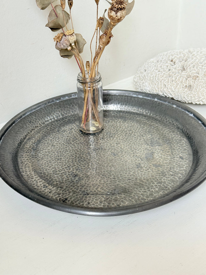 Vintage Harrods pewter drinks tray with hammered surface photographed on a white background.