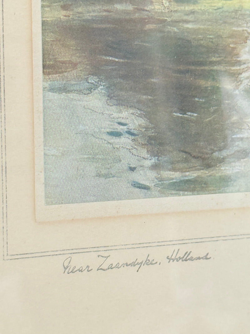 framed print of dutch windmill beside water in holland with reflection photographed on white surface