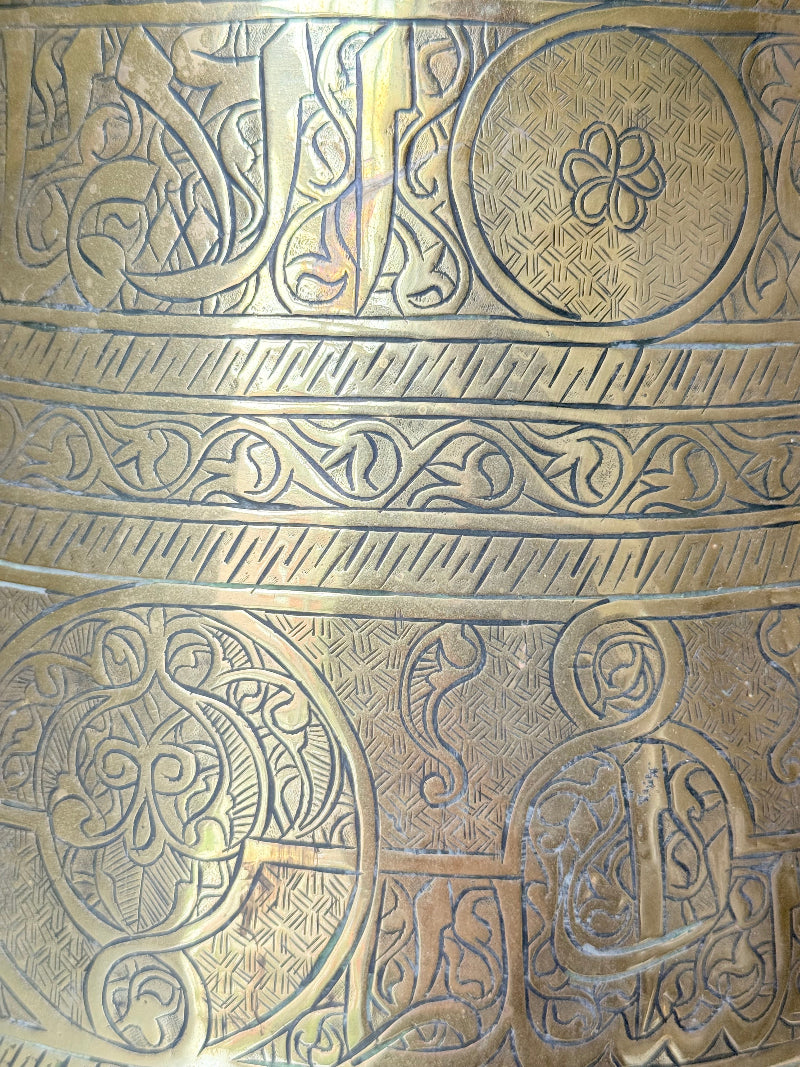 Large vintage brass pot with engraved decoration and aged patina, photographed on a white surface