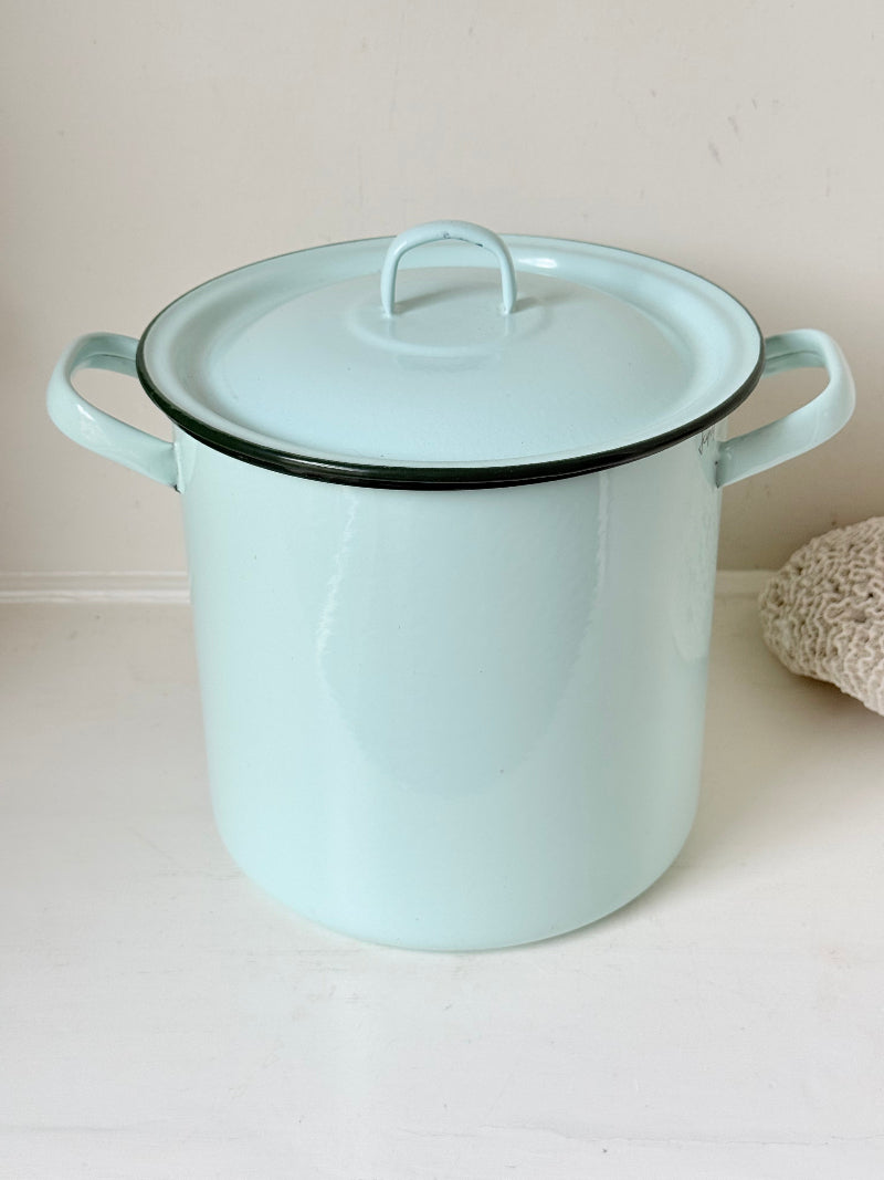 Vintage pale blue enamel bread bin with lid and handles, photographed on a white surface