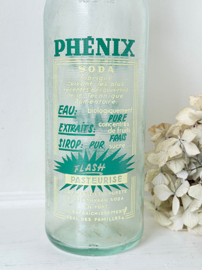 vintage french soda bottle phenix aqua green glass with ceramic swing top 31cm on white surface