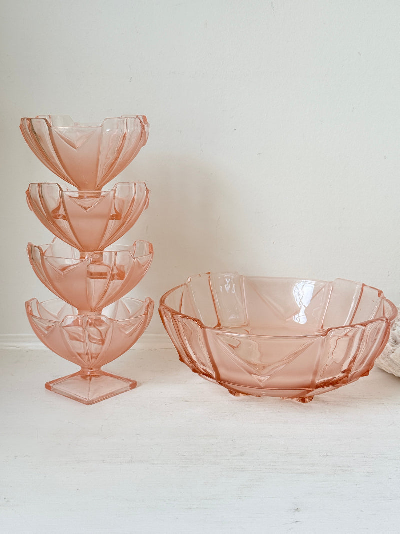 Art Deco pink pressed glass dessert service with scalloped serving bowl and four footed sundae dishes