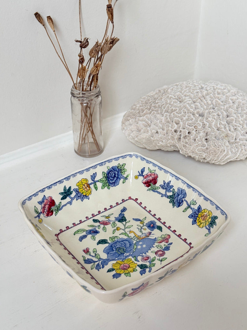 Vintage Mason’s ironstone serving dish with square form and spring floral pattern in blue, pink, yellow, and green, photographed on a white surface