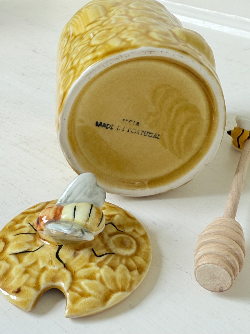 Secla pottery honey jar with lid, bee motif, and wooden honey spoon, made in Portugal, photographed on a white surface
