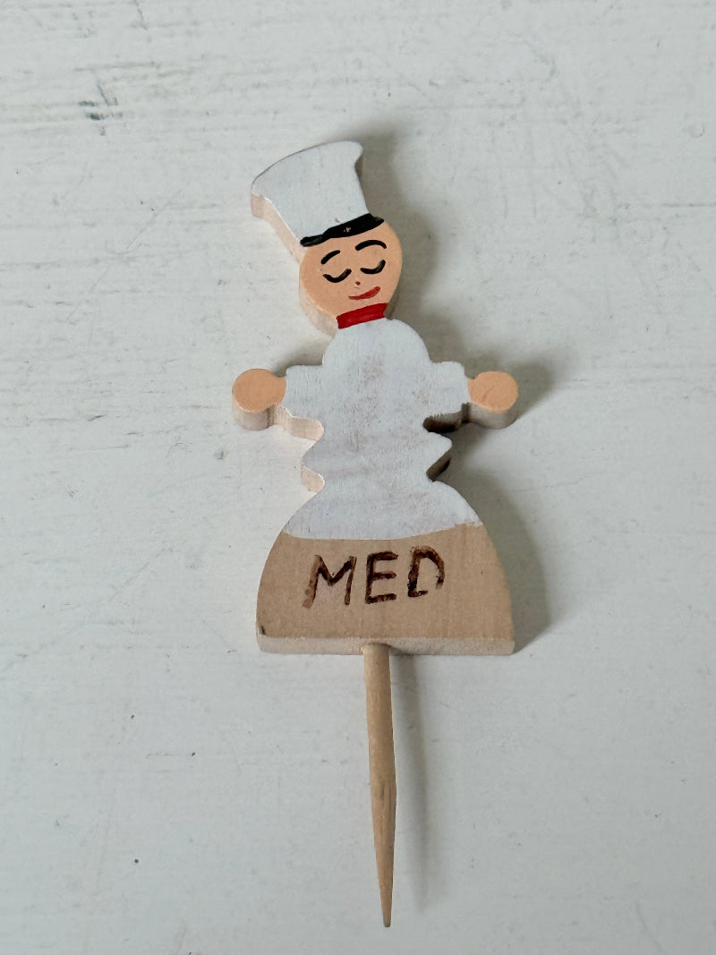 Vintage hand painted wooden steak markers on cocktail sticks labelled rare medium and well done, photographed on a white surface