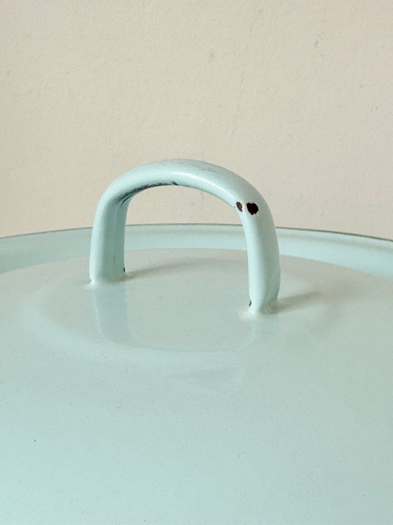 Vintage pale blue enamel bread bin with lid and handles, photographed on a white surface