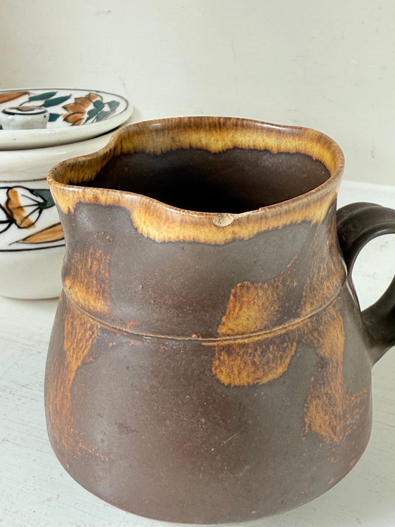 Studio pottery creamer and hand painted sugar bowl set, photographed on a white surface