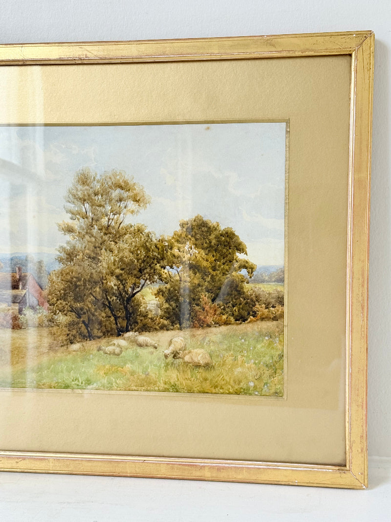 Antique watercolour landscape in gilt frame, countryside scene with trees, photographed on white surface.