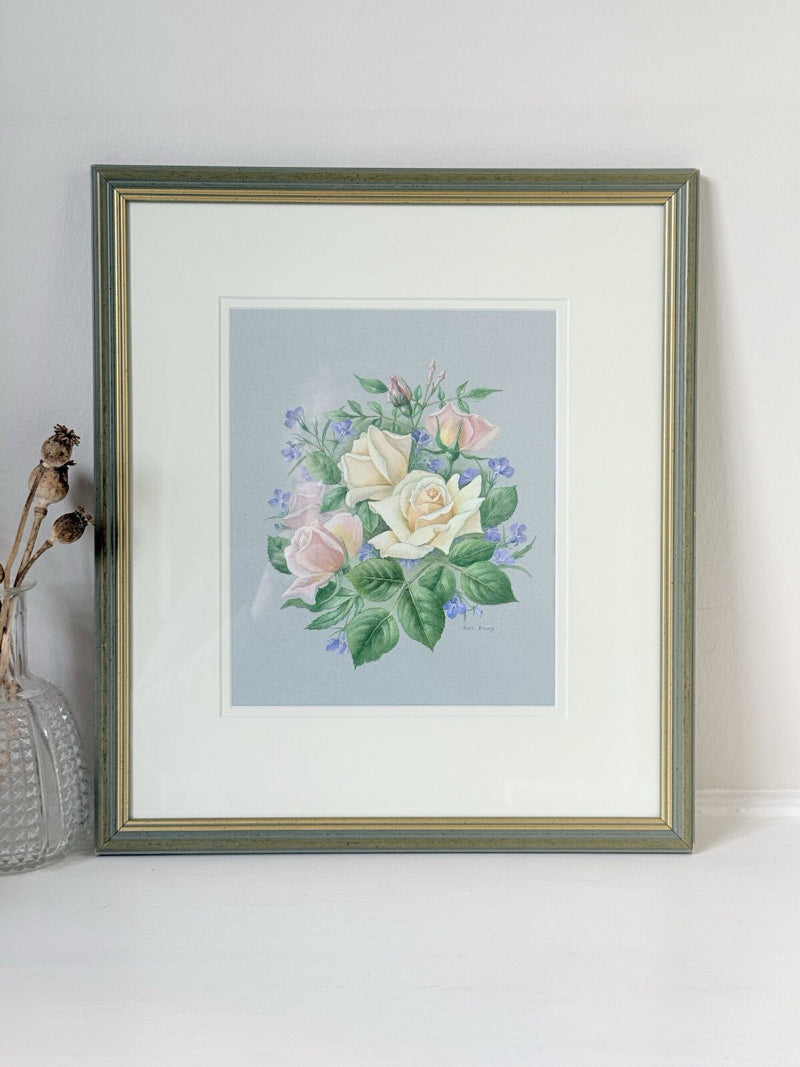Framed pencil drawing of pale yellow and blush roses with green leaves and purple flowers on a soft grey background, signed by artist Pam Ford.