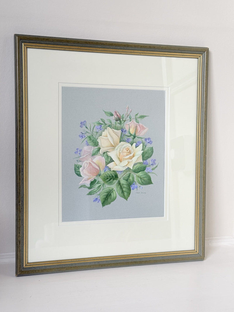 Framed pencil drawing of pale yellow and blush roses with green leaves and purple flowers on a soft grey background, signed by artist Pam Ford.