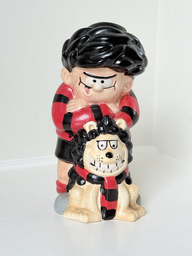 Dennis the Menace and Gnasher ceramic moneybox in red and black comic-style outfits, with vintage hand-painted detail.